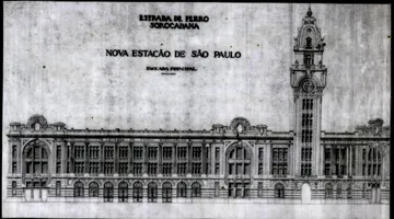 A imagem mostra o desenho do novo projeto da Estação Júlio Prestes, um prédio imponente, com muitos detalhes arquitetônicos, janelas, arabescos e uma grande torre de relógio.